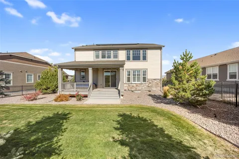 a view of a house with backyard porch and sitting area