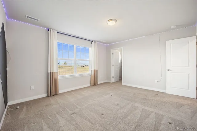 a view of a room with cabinet and a refrigerator