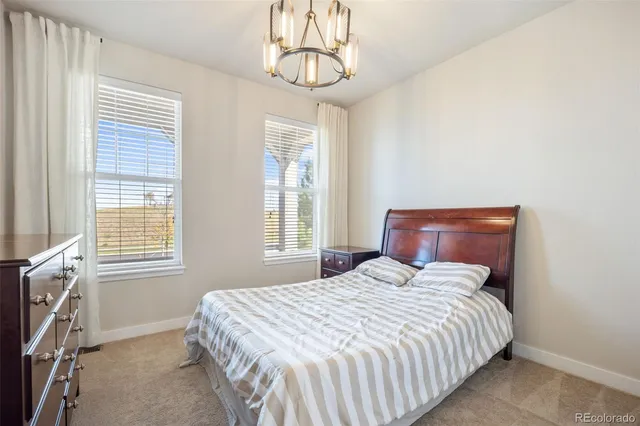 a bedroom with a bed and windows