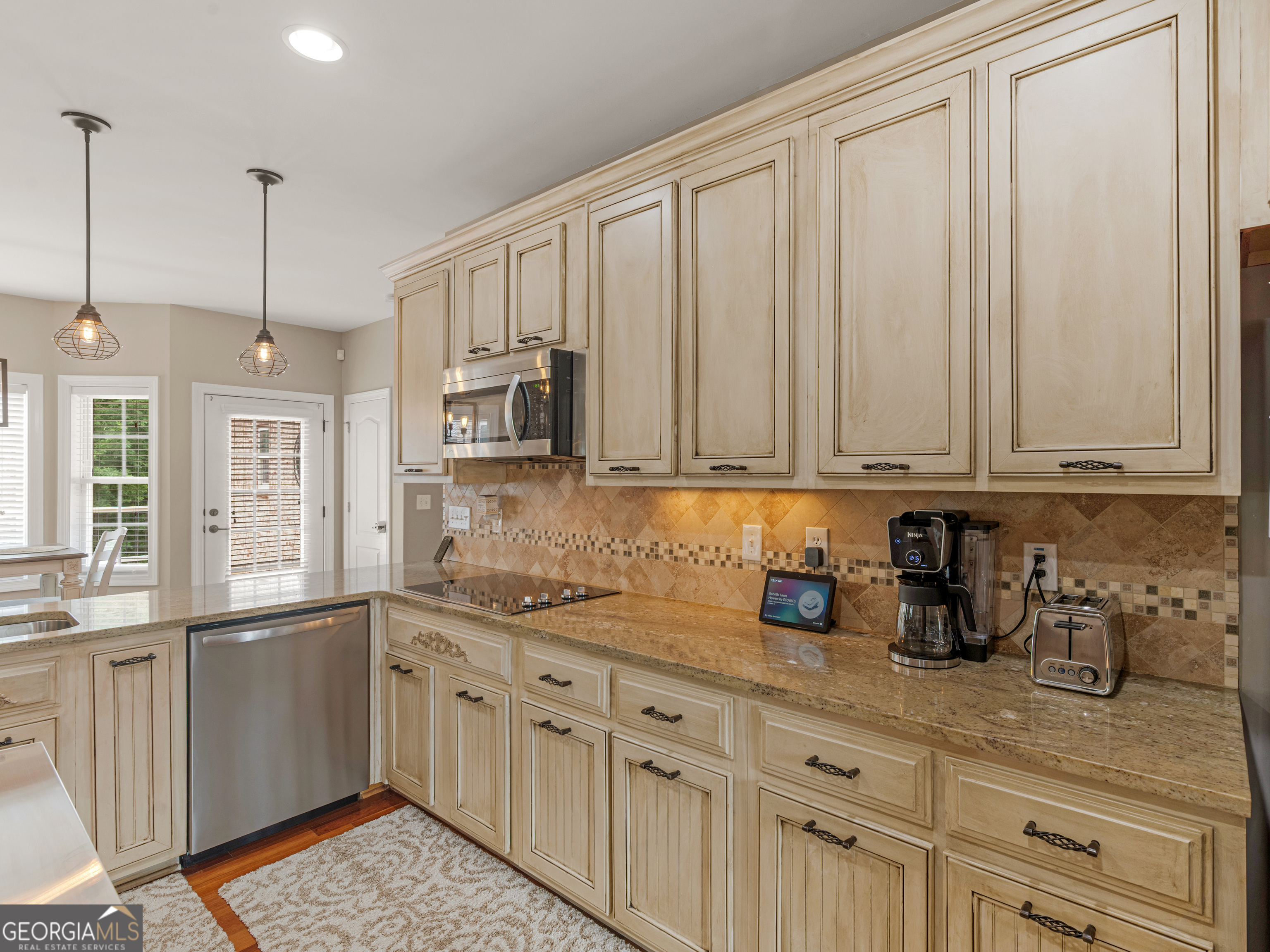 221 Hummingbird Court Hampton, GA 30228 - Photo 23 of 77 a kitchen with stainless steel appliances granite countertop a sink a stove and cabinets