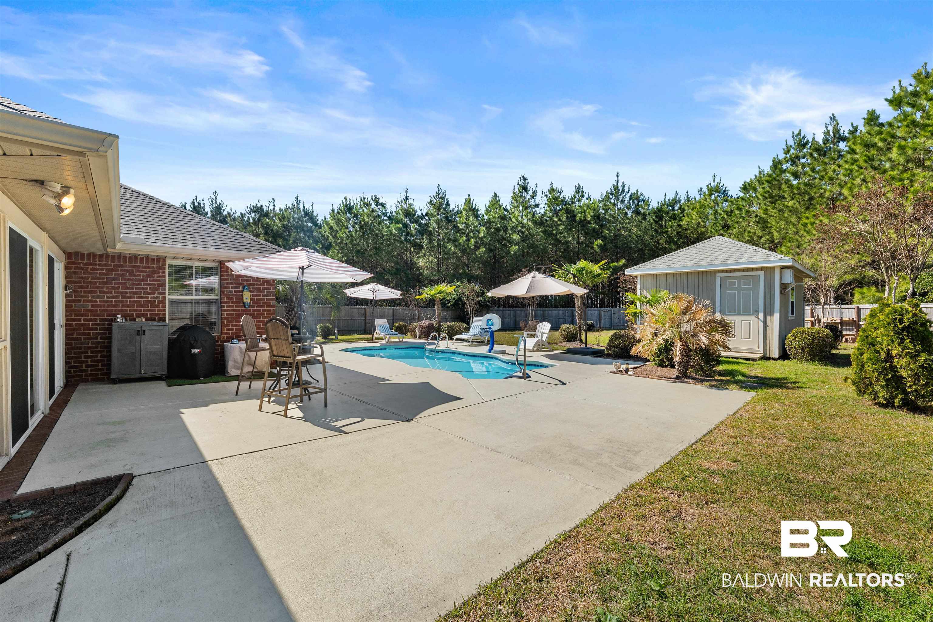 1850 Arcadia Drive Foley, AL 36535 - Photo 37 of 44 View of swimming pool with a fenced in pool, a patio, a fenced backyard, an outbuilding, and a storage unit