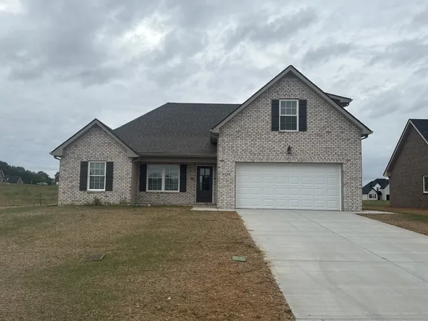 a front view of a house with yard and garage