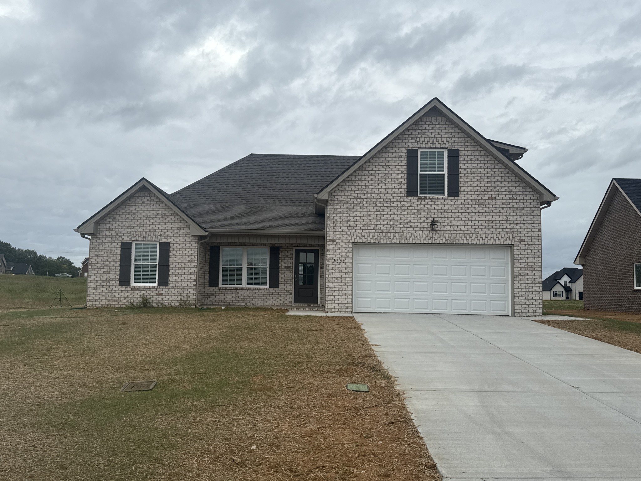 a front view of a house with yard and garage
