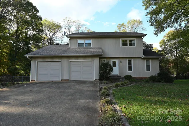 a front view of a house with a garden and yard