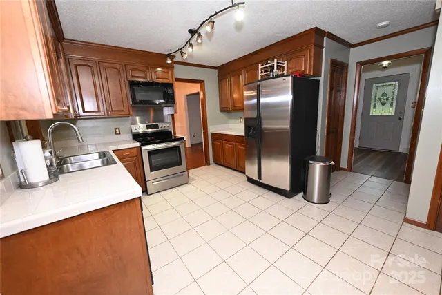 a view of empty room with window and wooden floor