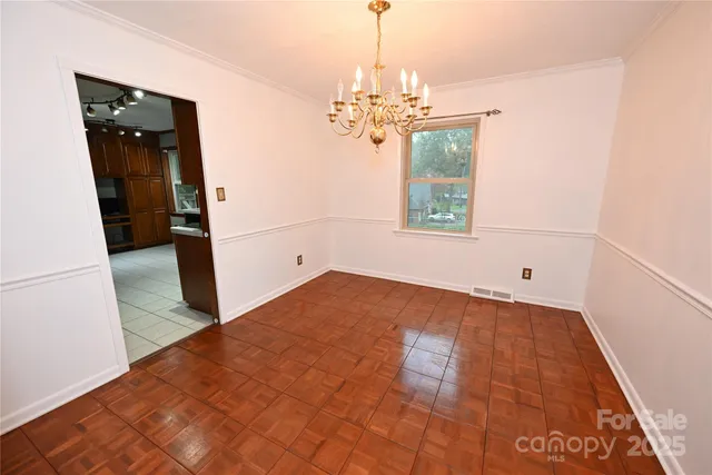 a view of an empty room with a fireplace and a window