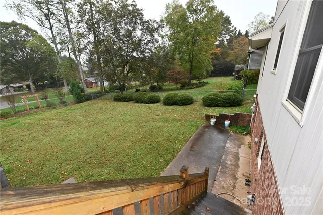 a backyard of a house with a yard and outdoor seating