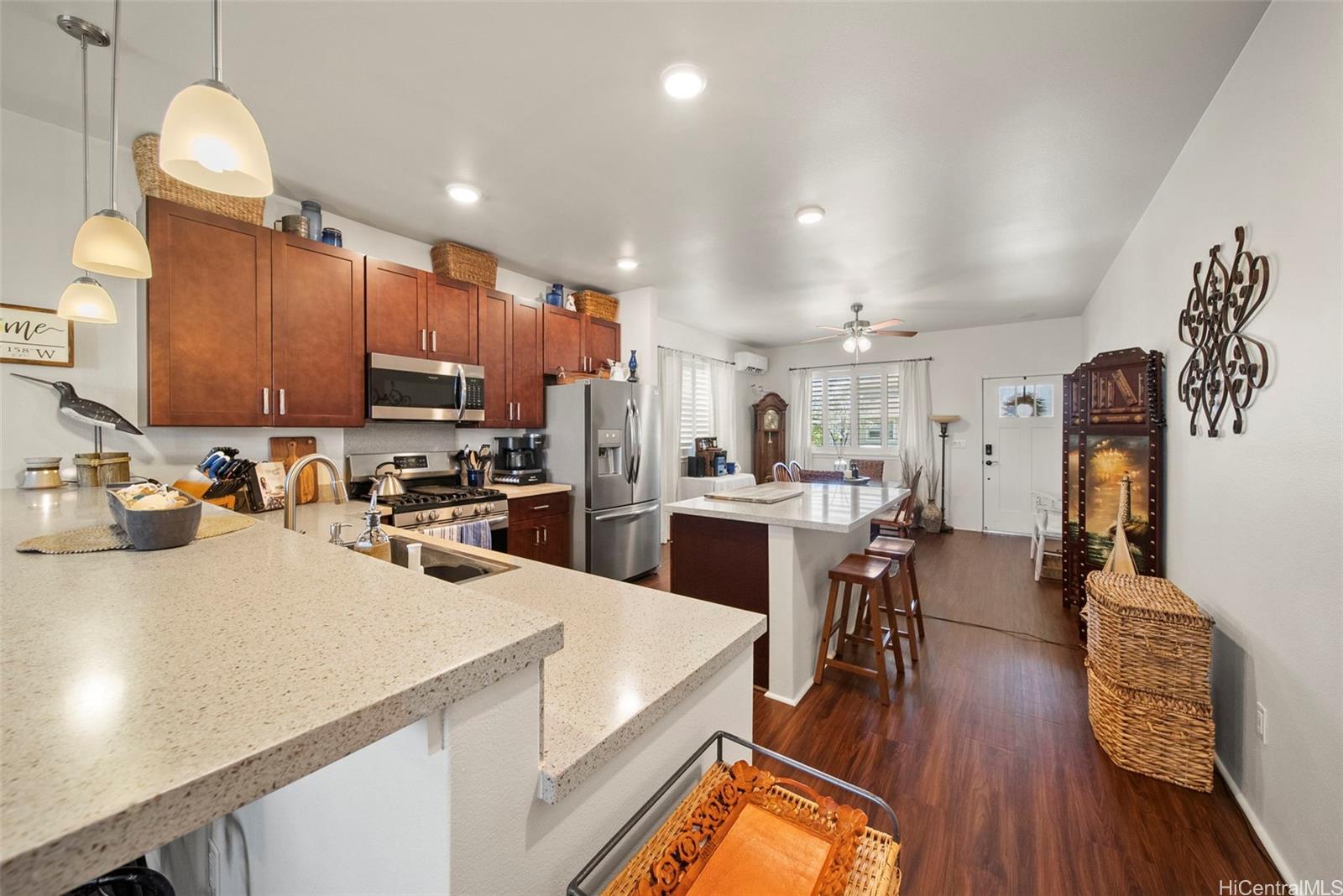 91-1129 Iliahialoe Loop Ewa Beach, HI 96706 - Photo 12 of 25 a kitchen with a sink appliances and wooden floor