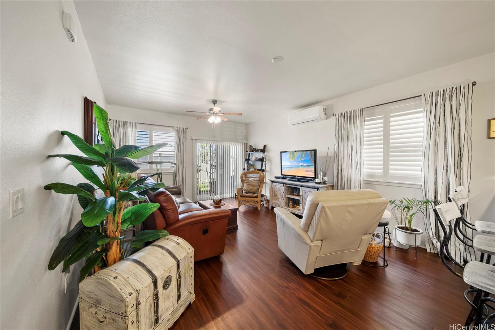 91-1129 Iliahialoe Loop Ewa Beach, HI 96706 - Photo 13 of 25 a living room with furniture fireplace and a potted plant