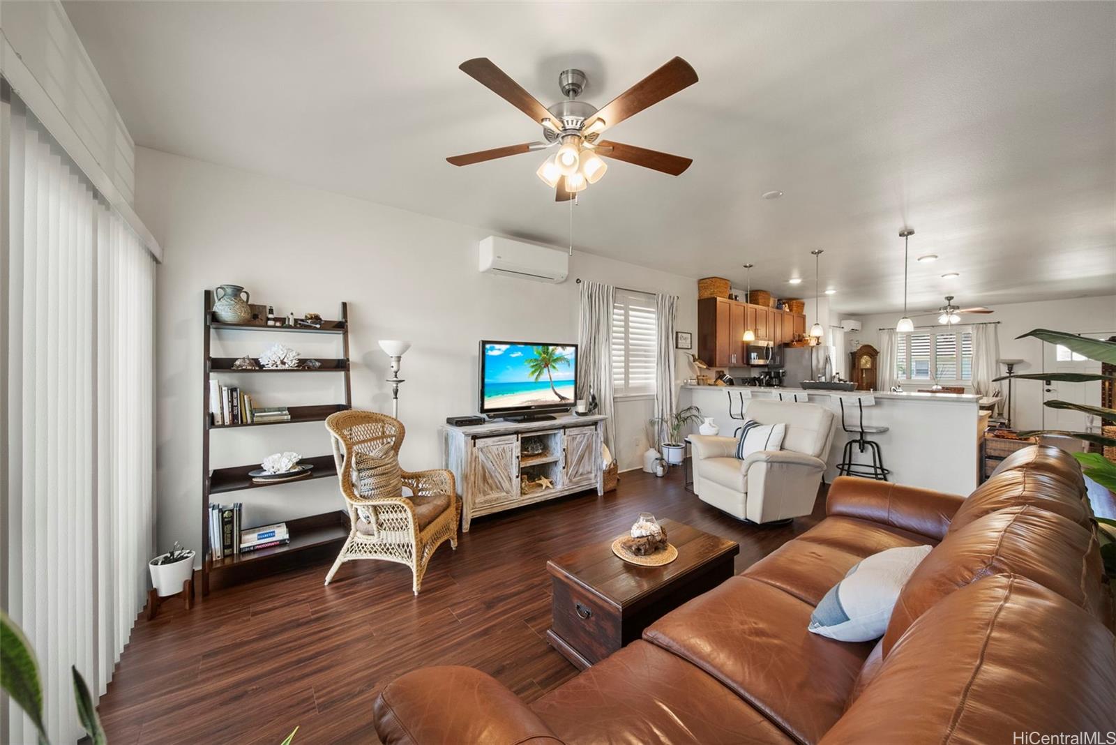 91-1129 Iliahialoe Loop Ewa Beach, HI 96706 - Photo 15 of 25 a living room with furniture and a wooden floor