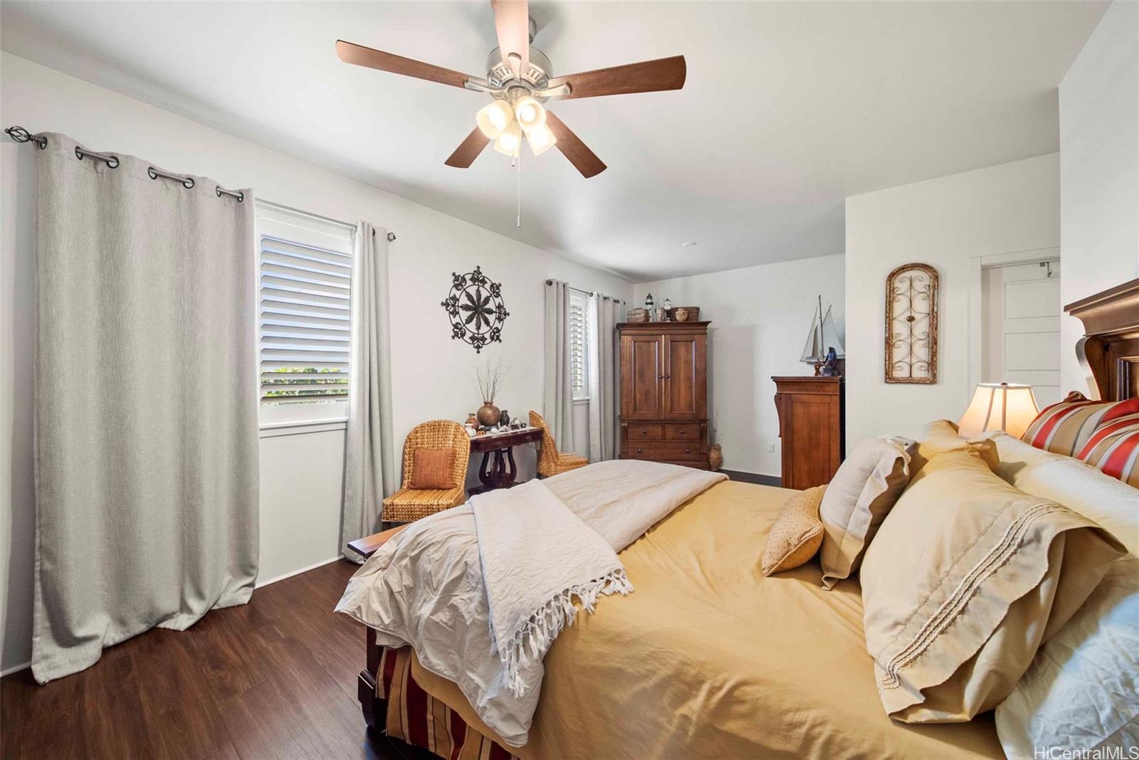 91-1129 Iliahialoe Loop Ewa Beach, HI 96706 - Photo 23 of 25 a bedroom with bed and wooden floor