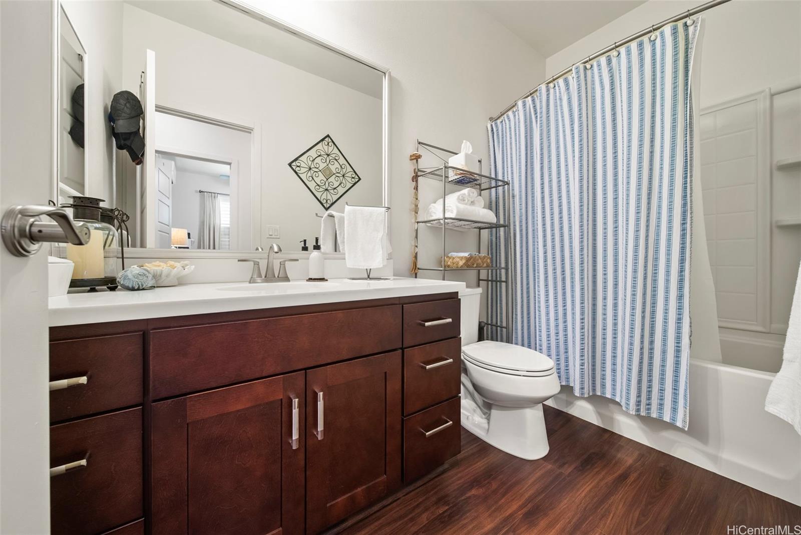 91-1129 Iliahialoe Loop Ewa Beach, HI 96706 - Photo 25 of 25 a bathroom with a toilet sink and mirror