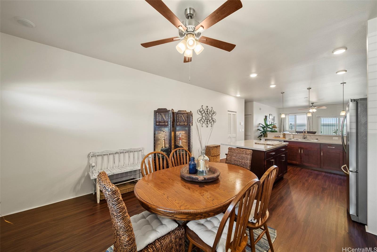 91-1129 Iliahialoe Loop Ewa Beach, HI 96706 - Photo 9 of 25 a view of a dining room with furniture and wooden floor