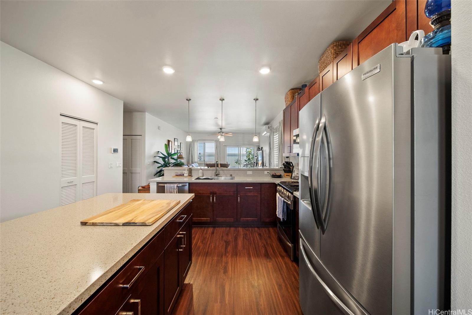 91-1129 Iliahialoe Loop Ewa Beach, HI 96706 - Photo 10 of 25 a kitchen with stainless steel appliances a refrigerator and a stove