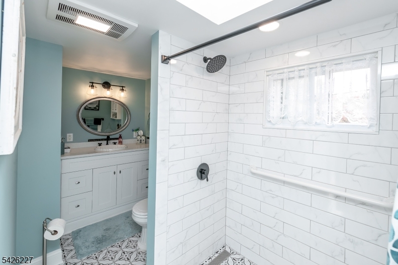 36 Main Street Flanders, NJ 07836 - Photo 30 of 49 a bathroom with a sink a mirror and shower