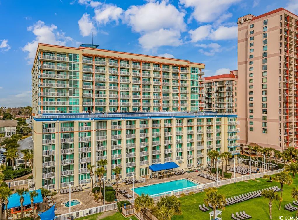 View of apartment building / complex featuring a community pool
