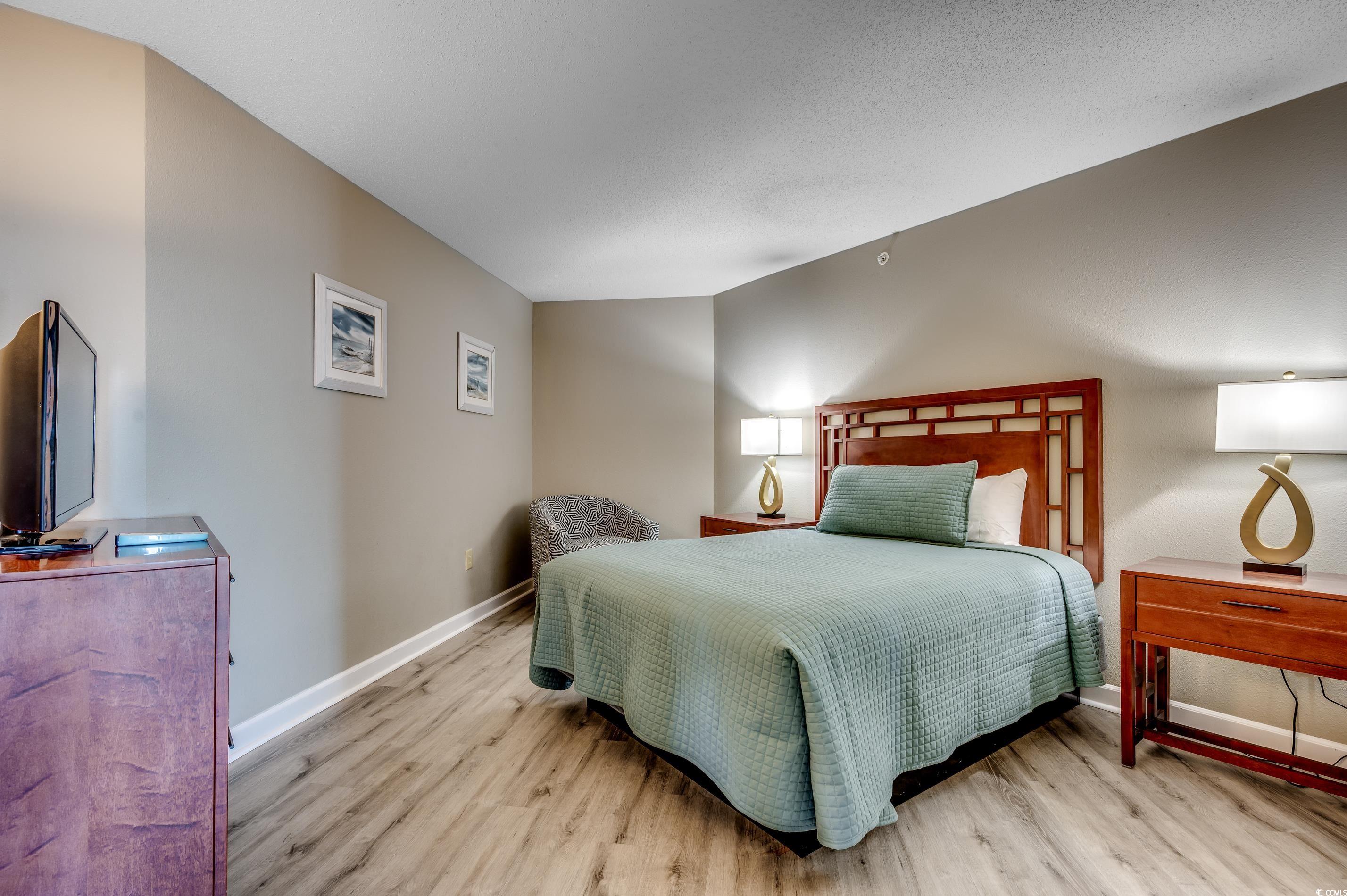 5200 North Ocean Boulevard, Unit 1037 Myrtle Beach, SC 29577 - Photo 23 of 40 Bedroom with light wood-style flooring