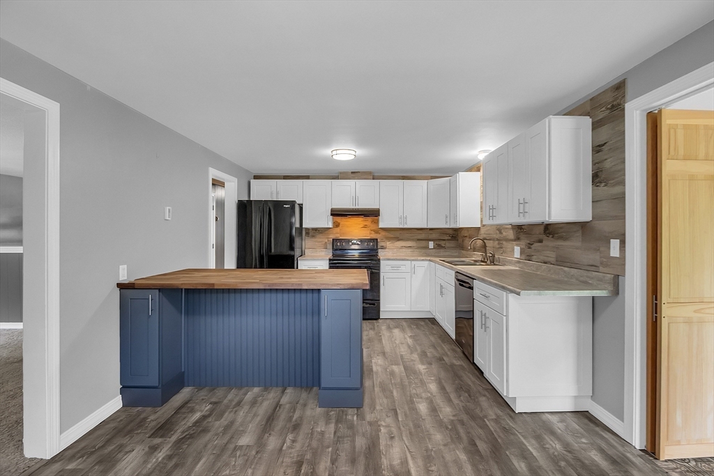 112 Walker Road Shirley, MA 01464 - Photo 11 of 33 a kitchen with granite countertop a stove top oven and cabinets