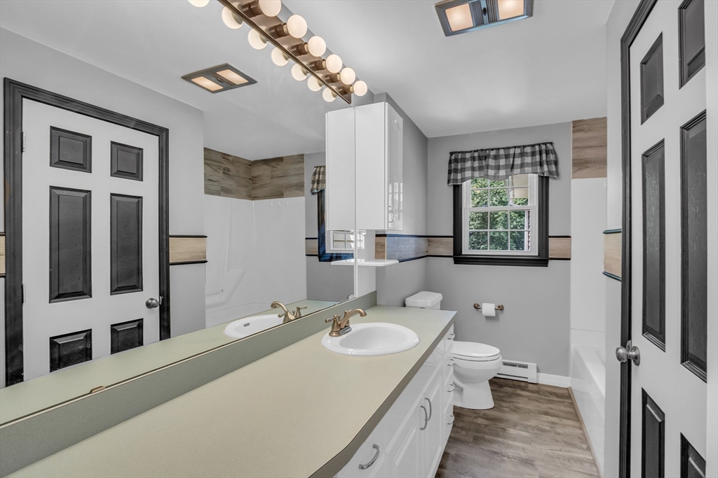 112 Walker Road Shirley, MA 01464 - Photo 17 of 33 a bathroom with a sink a toilet and mirror