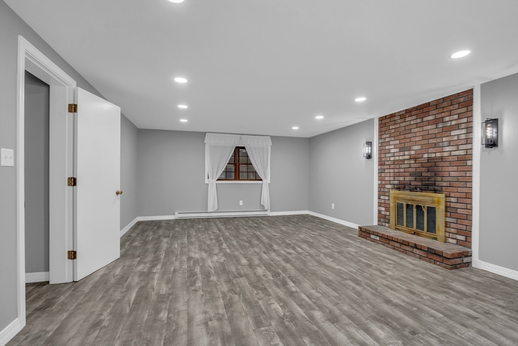112 Walker Road Shirley, MA 01464 - Photo 23 of 33 a view of empty room with wooden floor and fireplace
