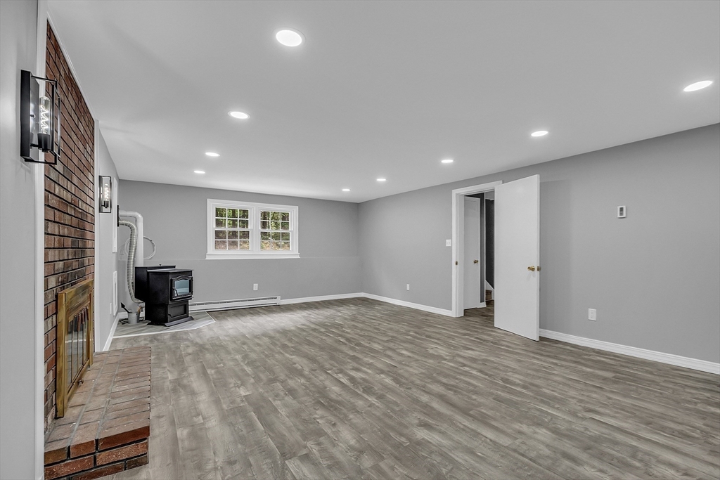 112 Walker Road Shirley, MA 01464 - Photo 24 of 33 a view of empty room with wooden floor and windows