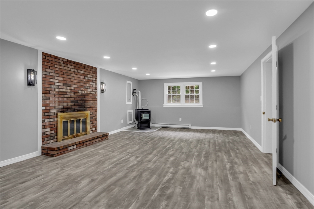 112 Walker Road Shirley, MA 01464 - Photo 25 of 33 a view of an empty room with wooden floor and a window