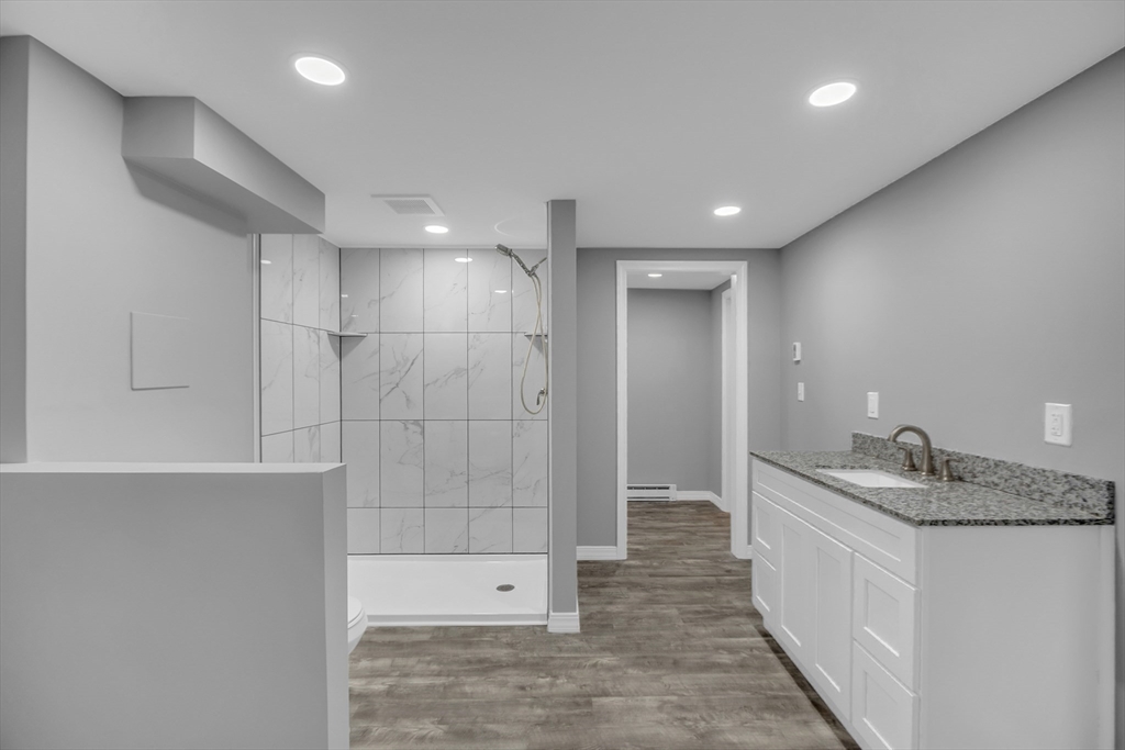 112 Walker Road Shirley, MA 01464 - Photo 28 of 33 a bathroom with a granite countertop sink a toilet and shower