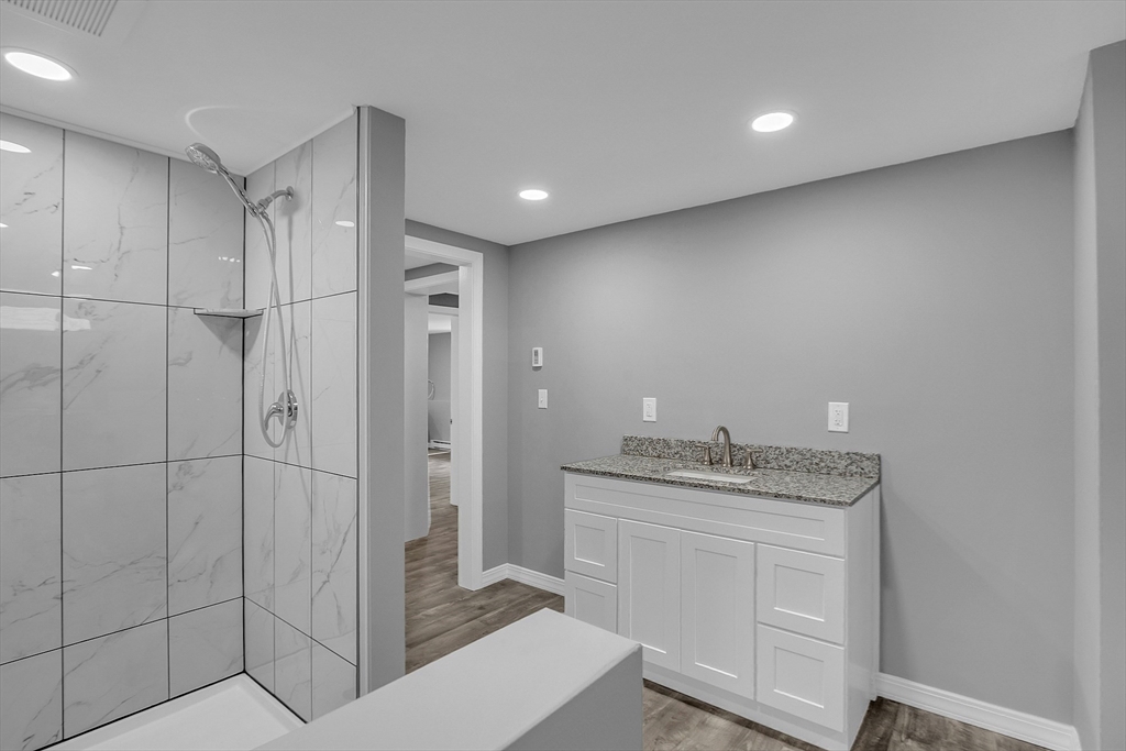 112 Walker Road Shirley, MA 01464 - Photo 29 of 33 a bathroom with a granite countertop sink a mirror and shower