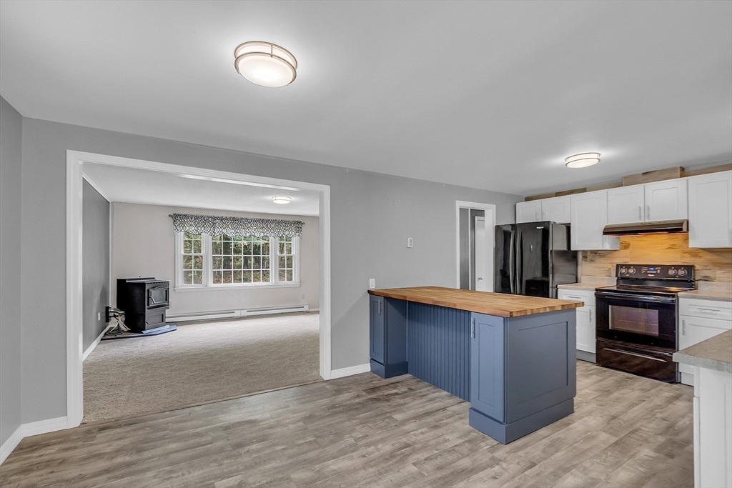 112 Walker Road Shirley, MA 01464 - Photo 10 of 33 a large kitchen with stainless steel appliances granite countertop a stove and a sink