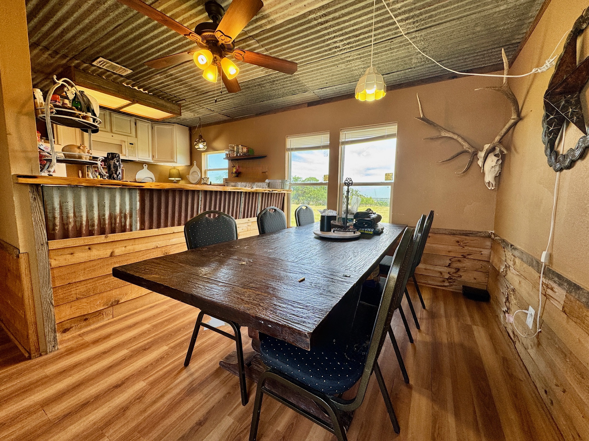 9 North Hcr 624 Road Hamilton, TX 76531 - Photo 17 of 40 a view of a patio with table and chairs with wooden floor