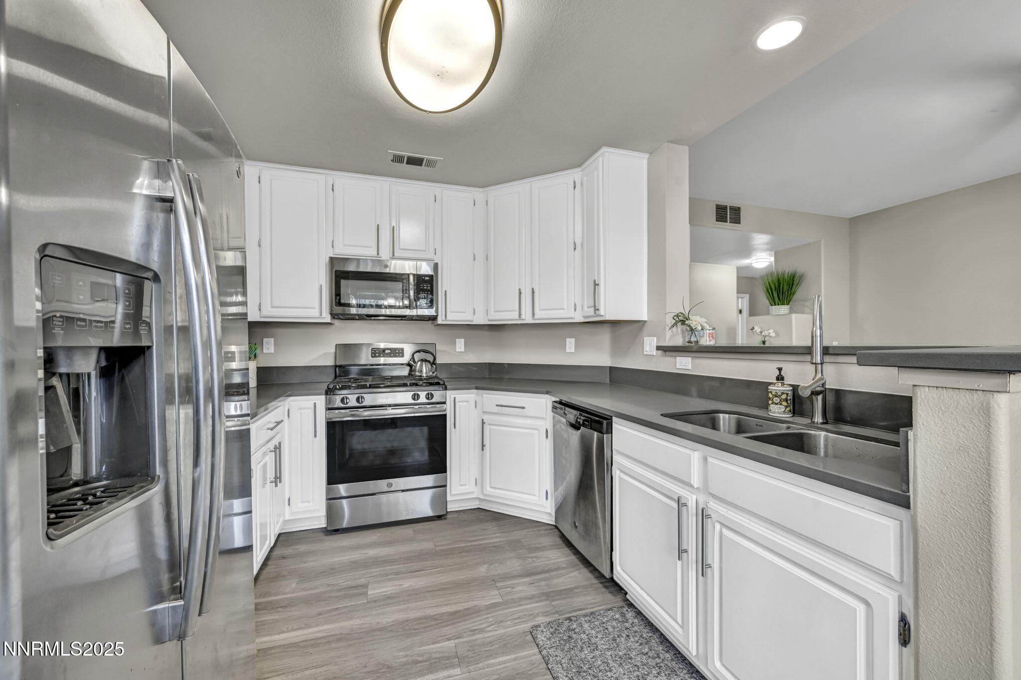 900 South Meadows Parkway, Unit 814 Reno, NV 89521 - Photo 11 of 43 a kitchen with cabinets stainless steel appliances and a sink