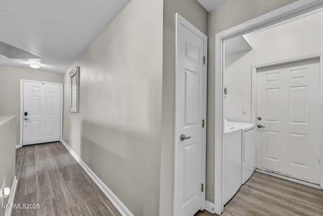 a view of a hallway with wooden floor