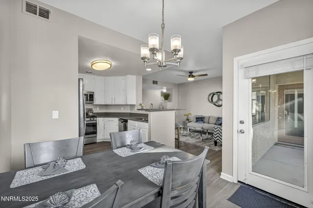 a very nice looking dining room with a table and chairs