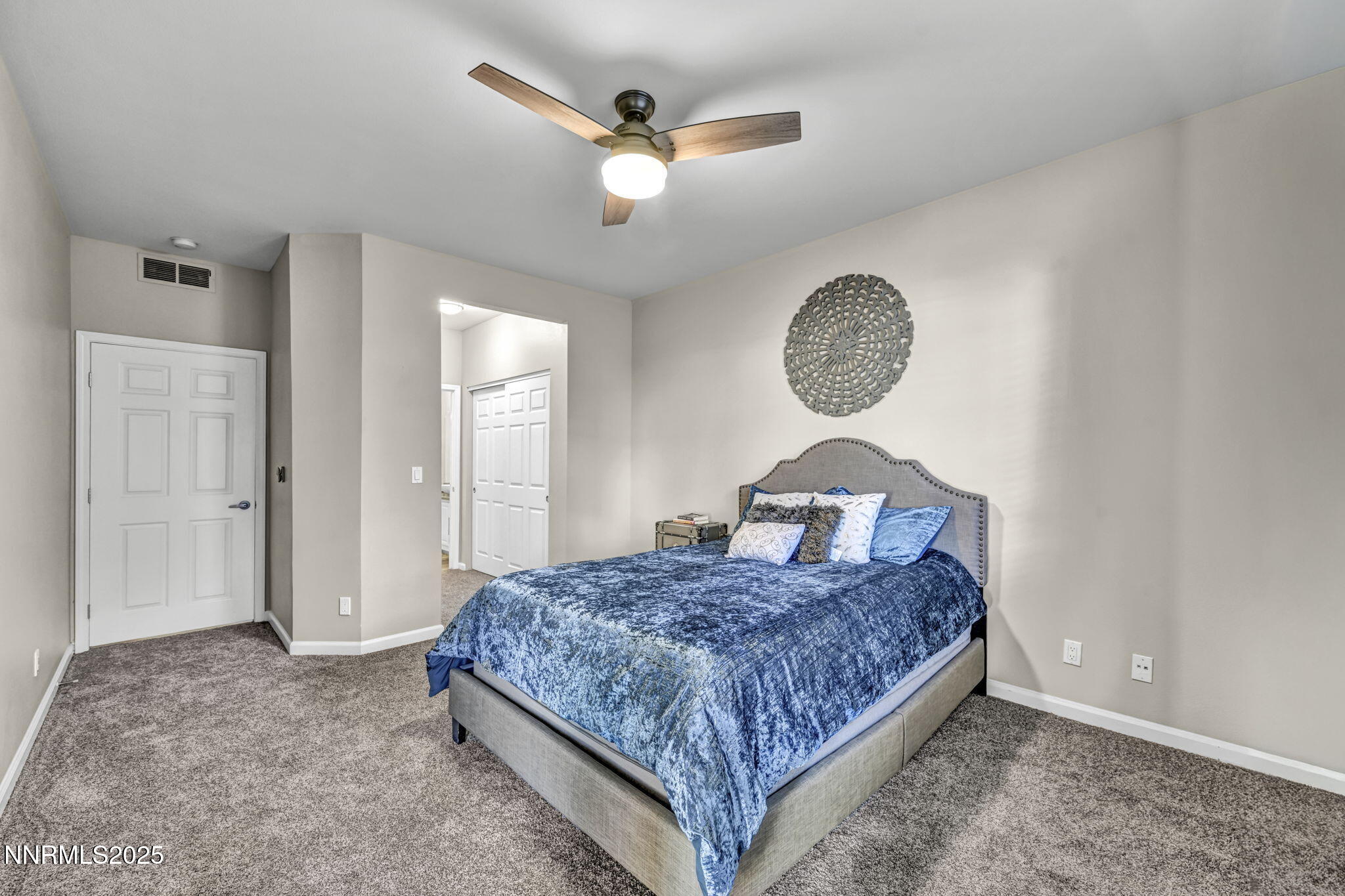 900 South Meadows Parkway, Unit 814 Reno, NV 89521 - Photo 17 of 43 a bedroom with a large bed and a chandelier