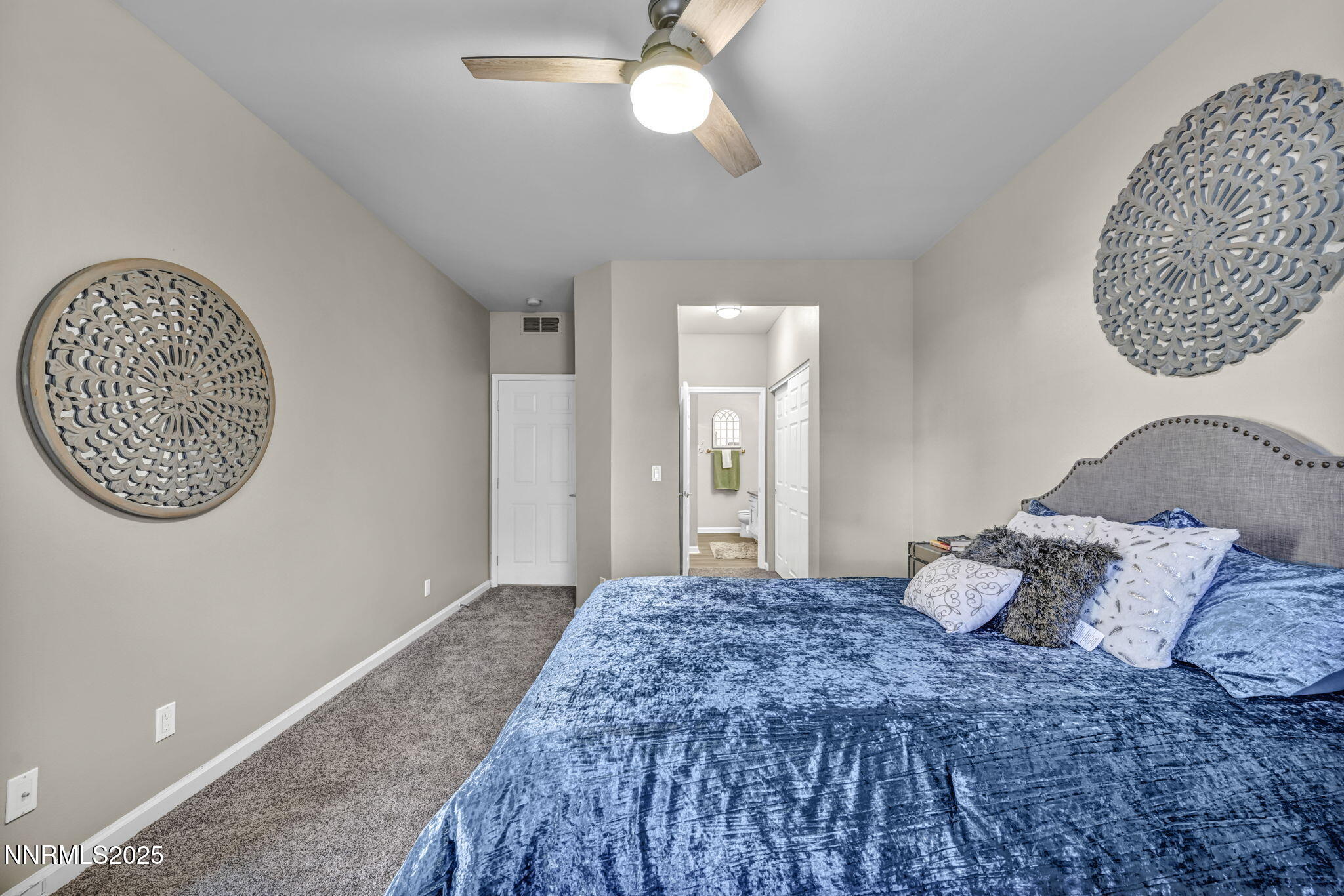 900 South Meadows Parkway, Unit 814 Reno, NV 89521 - Photo 18 of 43 a bedroom with a large bed and a chandelier