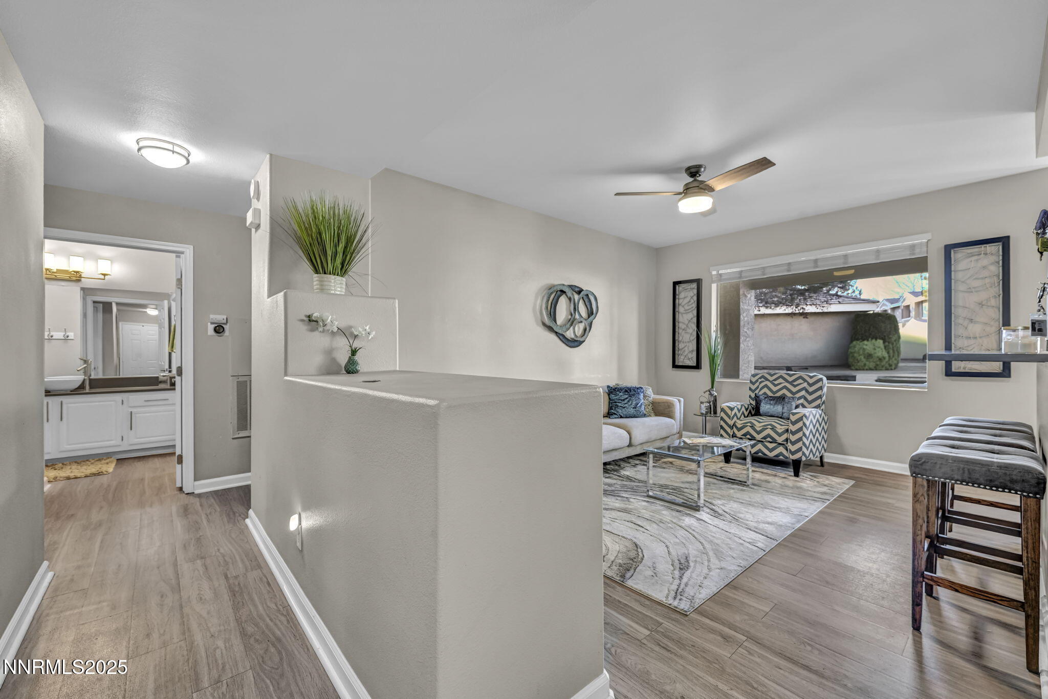 900 South Meadows Parkway, Unit 814 Reno, NV 89521 - Photo 3 of 43 a living room with furniture and a wooden floor