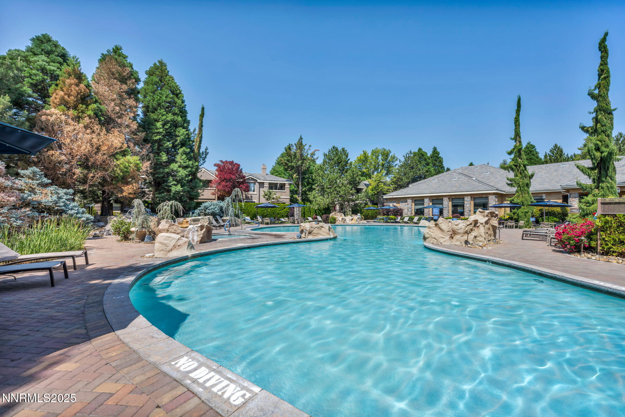 900 South Meadows Parkway, Unit 814 Reno, NV 89521 - Photo 32 of 43 a view of a swimming pool and lounge chairs in patio
