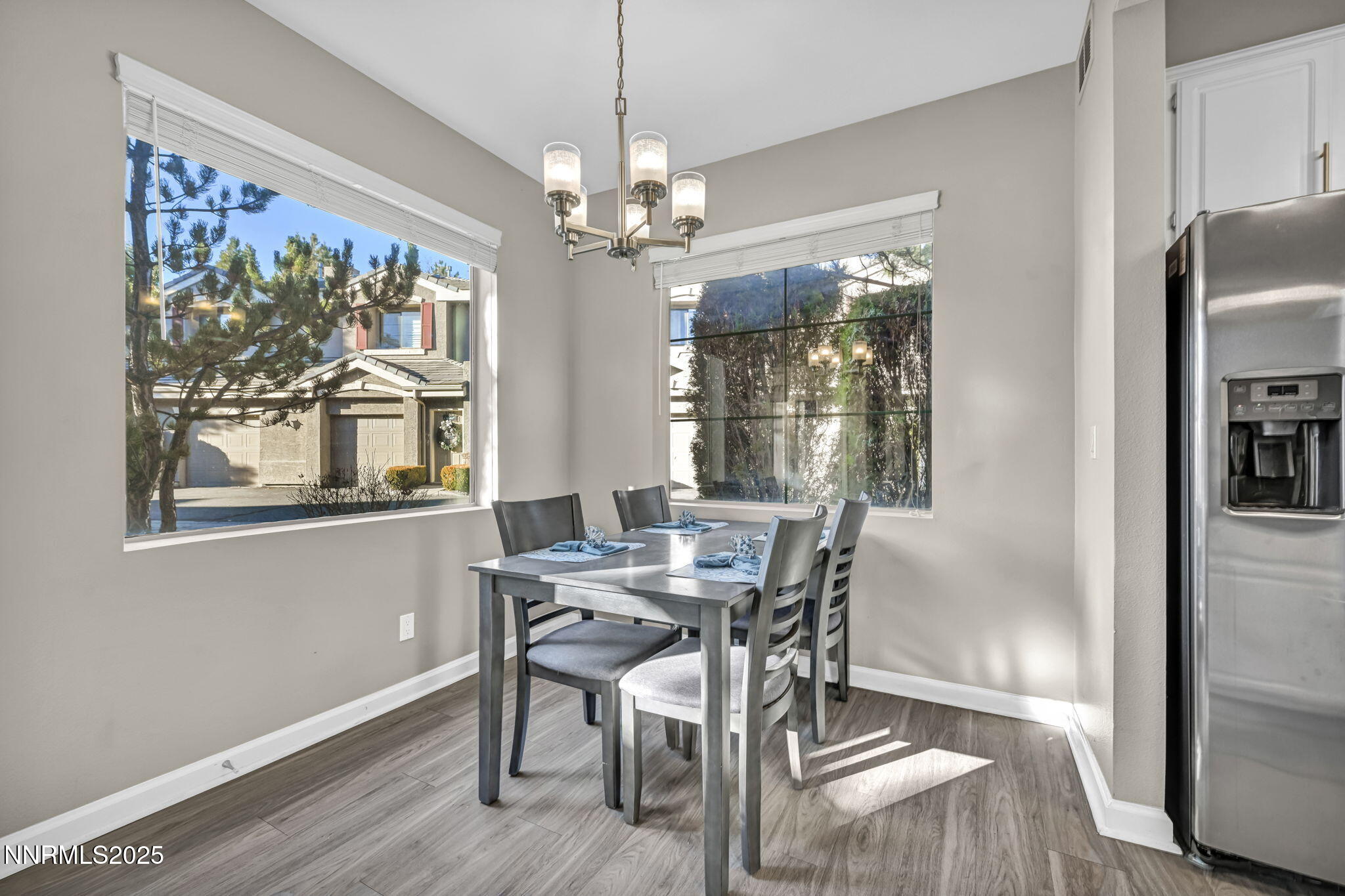 900 South Meadows Parkway, Unit 814 Reno, NV 89521 - Photo 9 of 43 a view of a dining room with furniture a chandelier and wooden floor