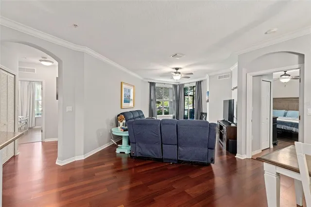 a living room with furniture and a wooden floor