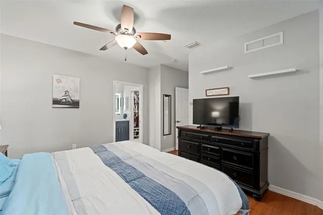 a bedroom with a bed and a flat screen tv