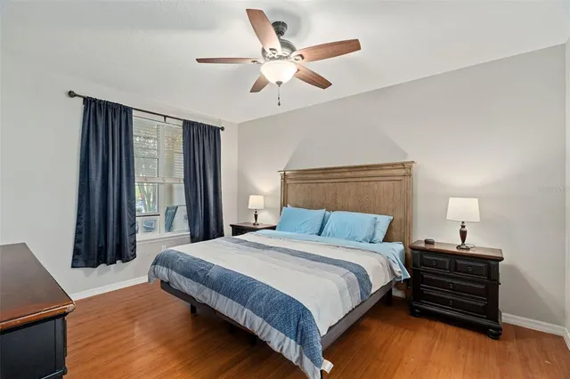 a bedroom with a large bed and a chandelier