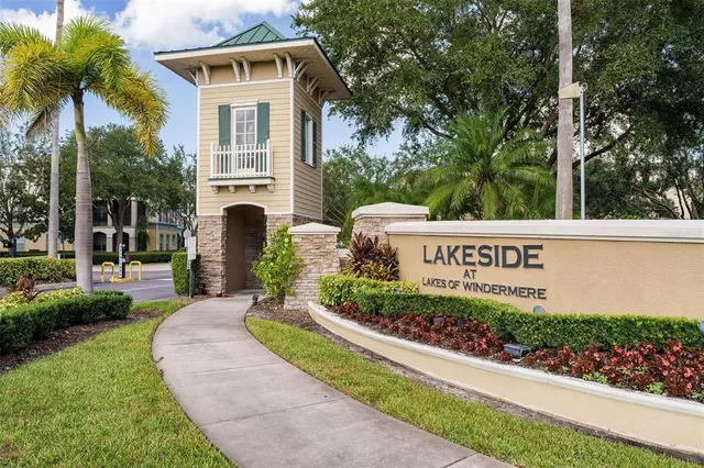a view of sign board with flower garden