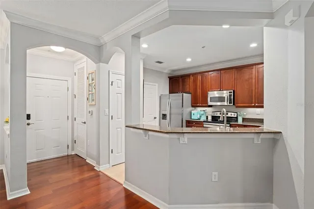 a kitchen with stainless steel appliances a refrigerator and microwave