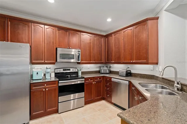a kitchen with a sink stove top oven and cabinets
