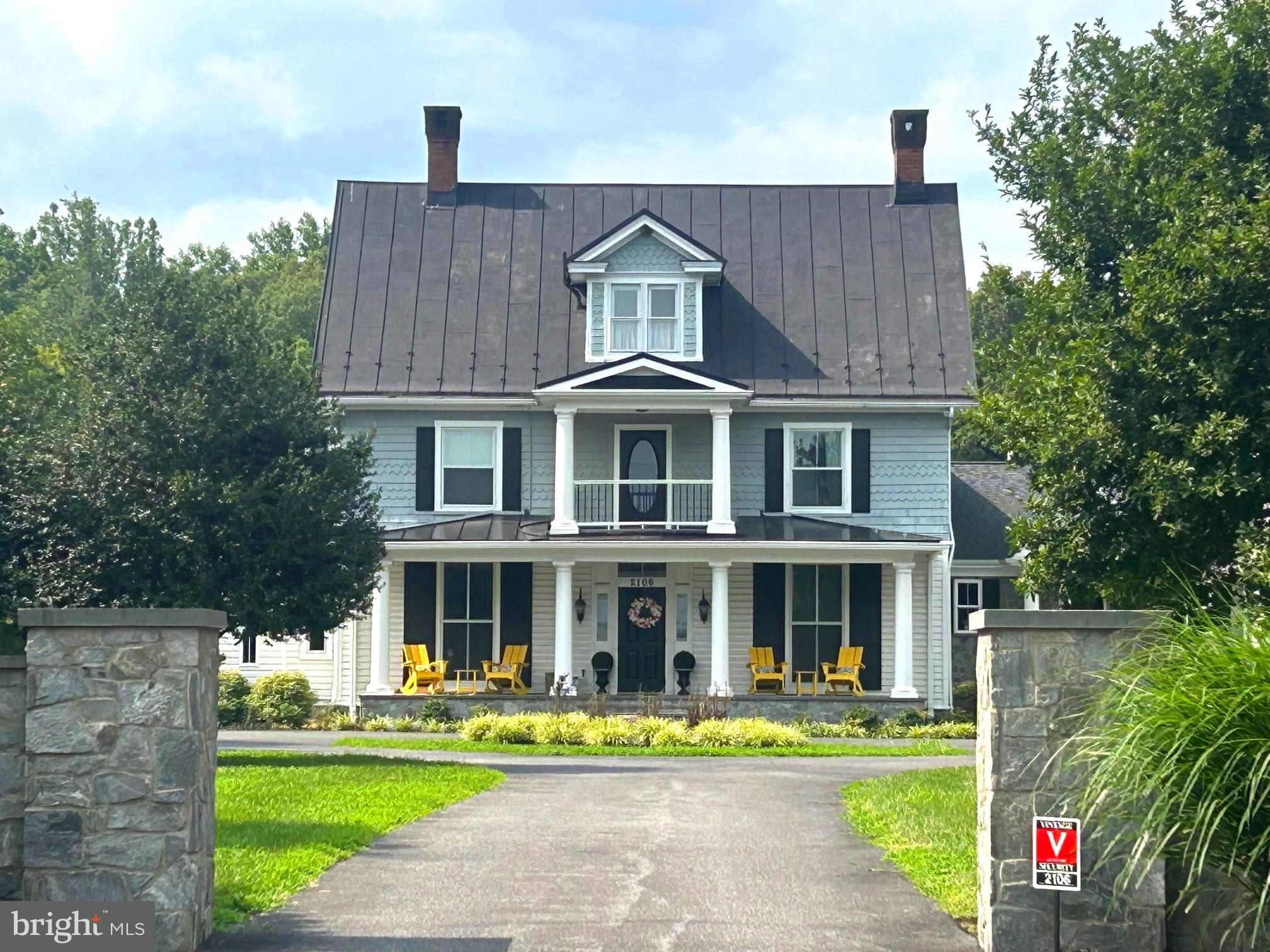 a front view of a house with a yard table and chairs