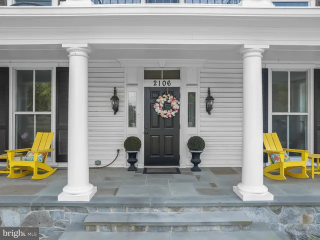 a view of a building with sitting area and garden
