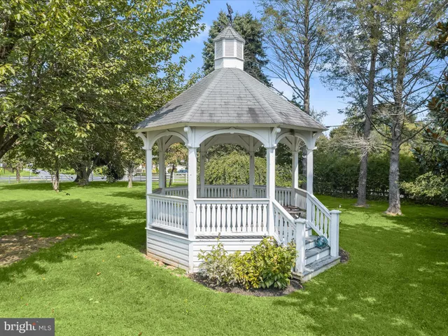 a view of a house with a yard and potted plants
