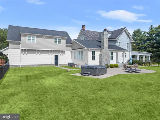 a view of a house with backyard and porch
