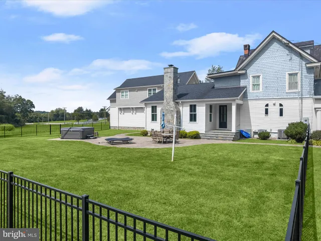 a view of backyard with seating space and trees
