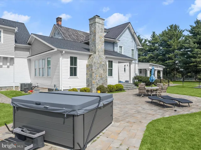 a aerial view of a house with a yard table and chairs